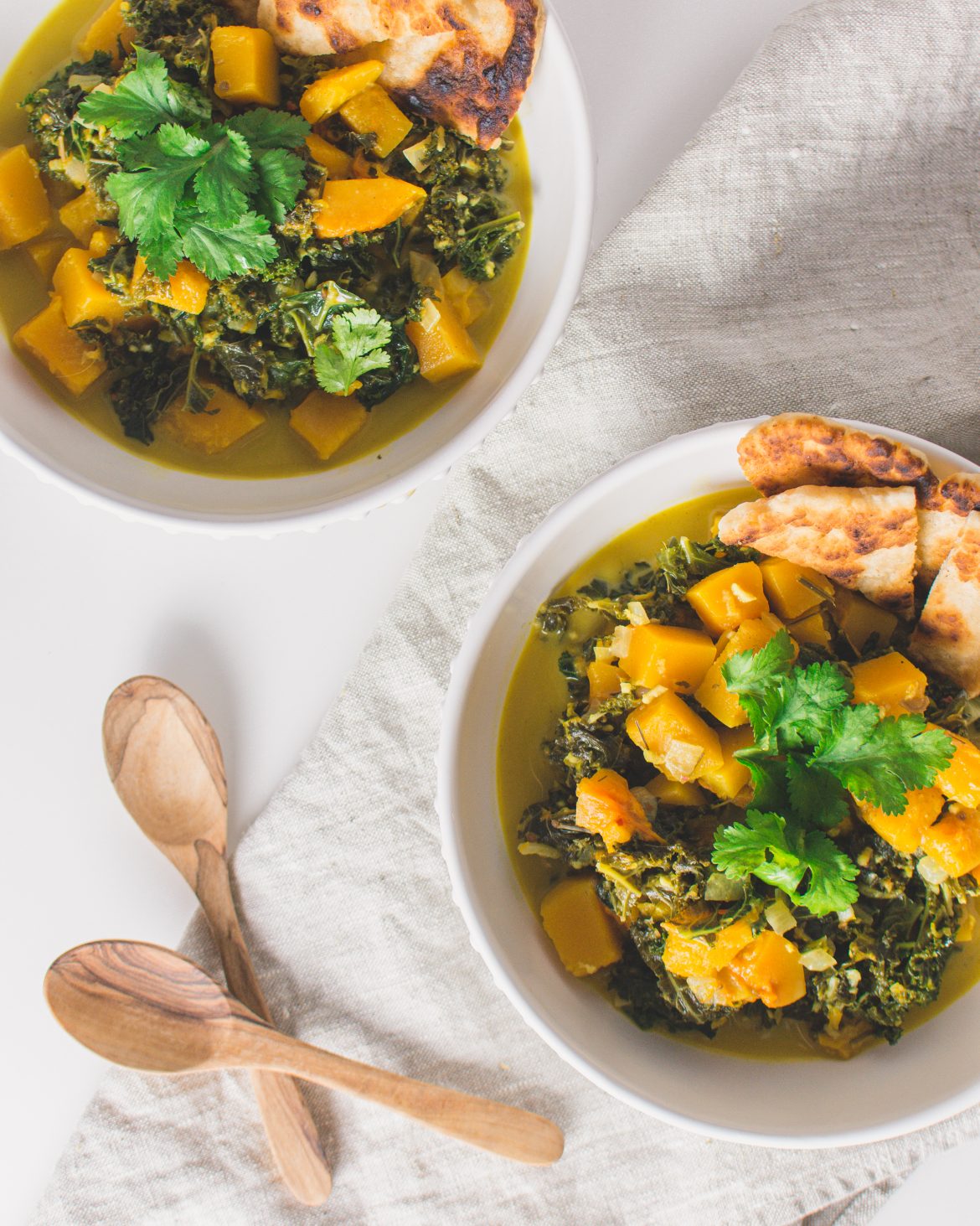 Vegan Pumpkin Kale Curry - Butternut Squash and Kale make the best vegan curry! It's easy to make, healthy and a comfort food. You can make the pumpkin kale curry in one pot and make it for lunch or dinner. Serve with homemade naan bread and enjoy this delicious recipe! #vegancurry #pumpkincurry #kalerecipe #veganrecipe #vegetarian #coconutmilk #kale